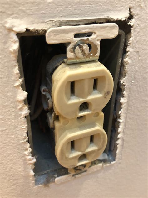 mounting hole in electrical outlet